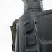 Close-up of a black monocular device showing side buttons and part of the eyepiece against a white background.