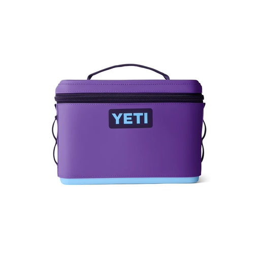 A purple YETI cooler bag with a black zipper, black handle, and a light blue bottom base, shown on a plain white background.