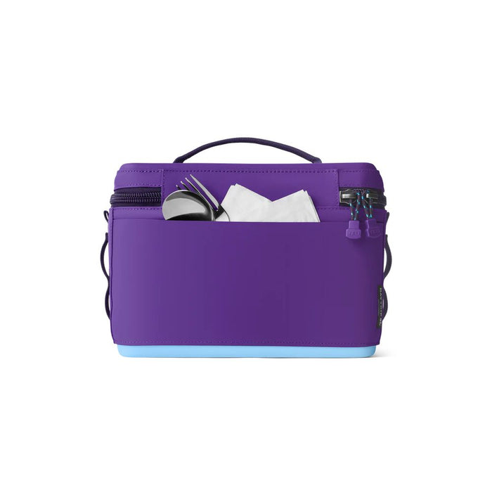A purple neoprene diaper pail bag with a light blue bottom base, shown on a white background with its front pocket open to display its storage capacity.