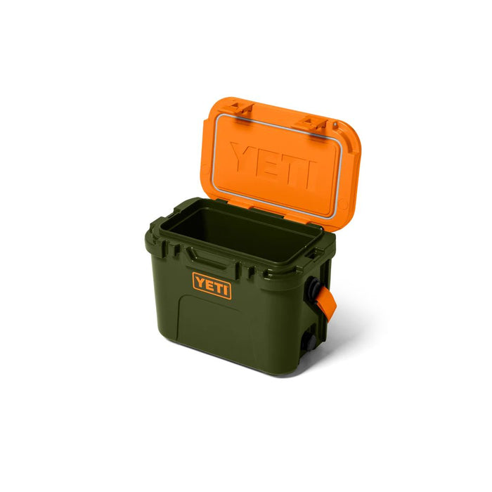 A YETI cooler in olive green with a bright orange lid, shown open on a clean white background.