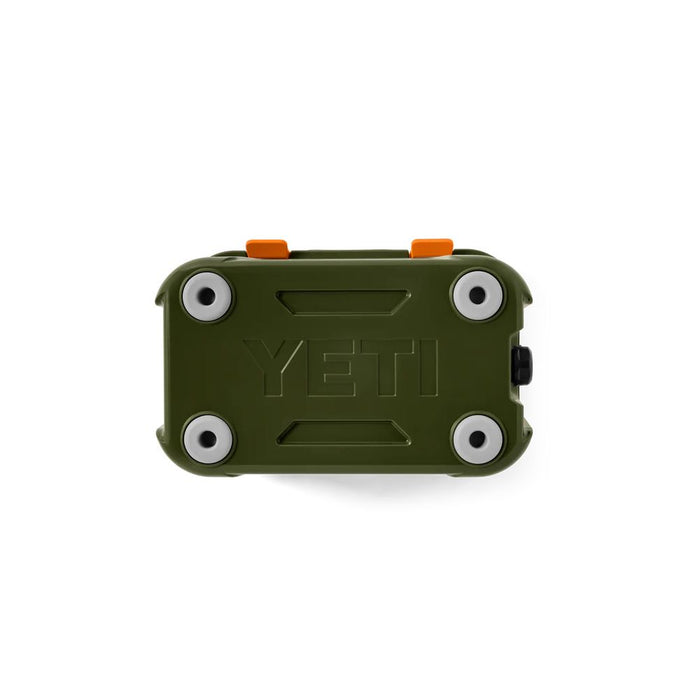 An olive green YETI cooler shown from the bottom, featuring white circular grommets around the corners and two small orange accents on top, set against a plain white background.