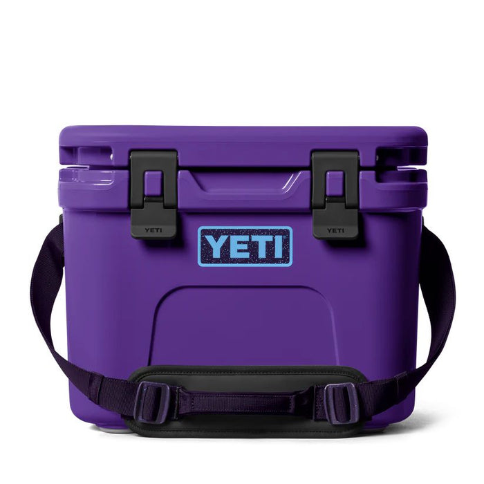 Purple YETI cooler with black straps on a white background