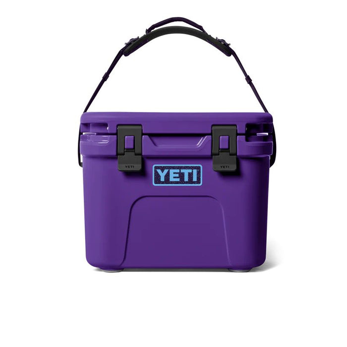 A purple YETI cooler with black latches and a black carrying handle, shown against a plain white background.
