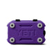 A purple YETI hard cooler shown from the bottom front view, featuring the embossed YETI logo and four gray protective corner bumpers on a white background.