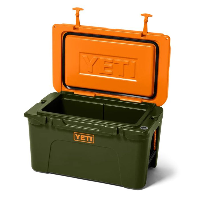 A YETI cooler shown open on a white background, with an olive green body and a bright orange lid. The YETI logo is visible on both the lid and the front of the cooler.